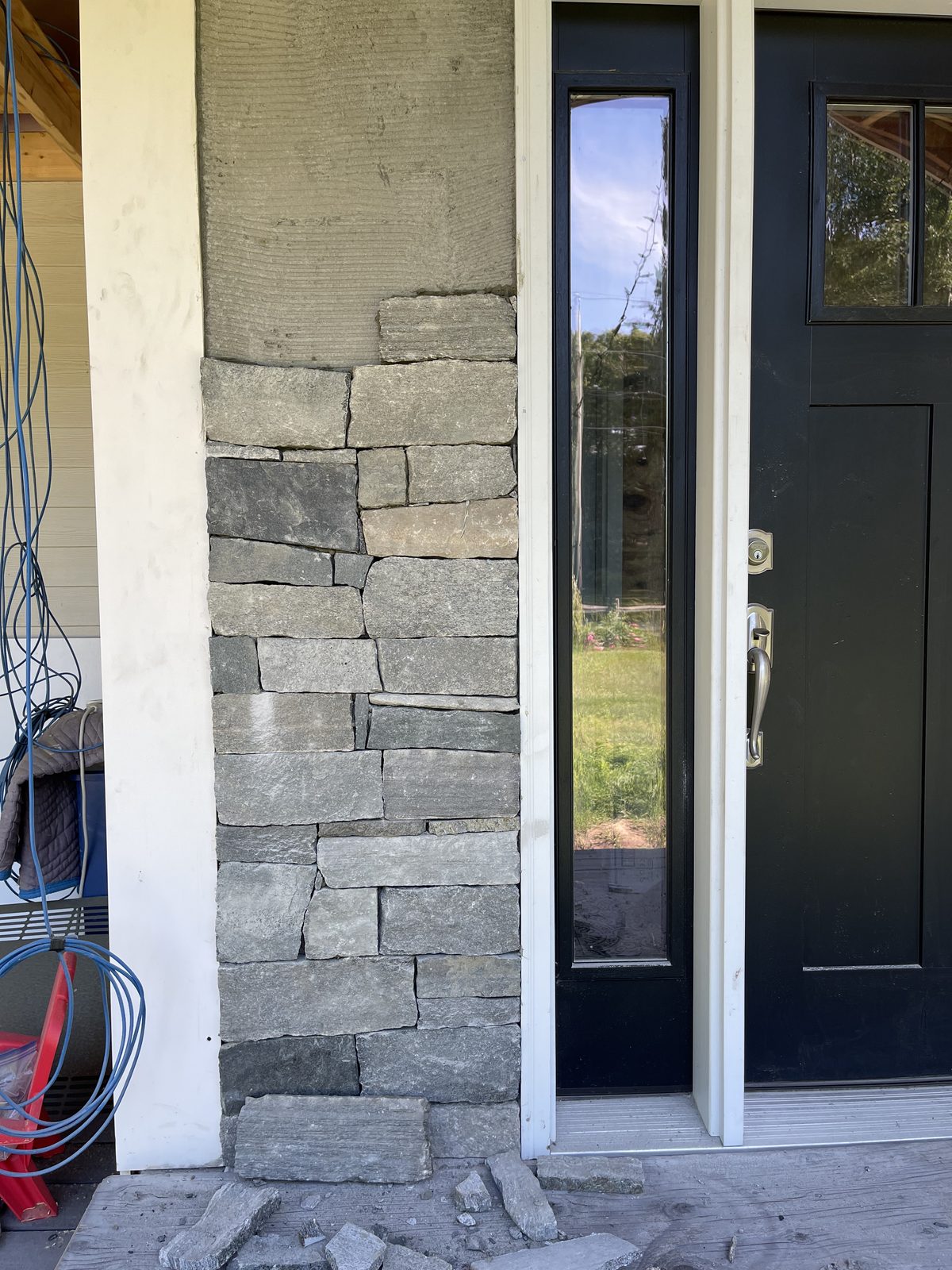 Natural stone veneer installation underway at a Bolton Massachusetts entry
