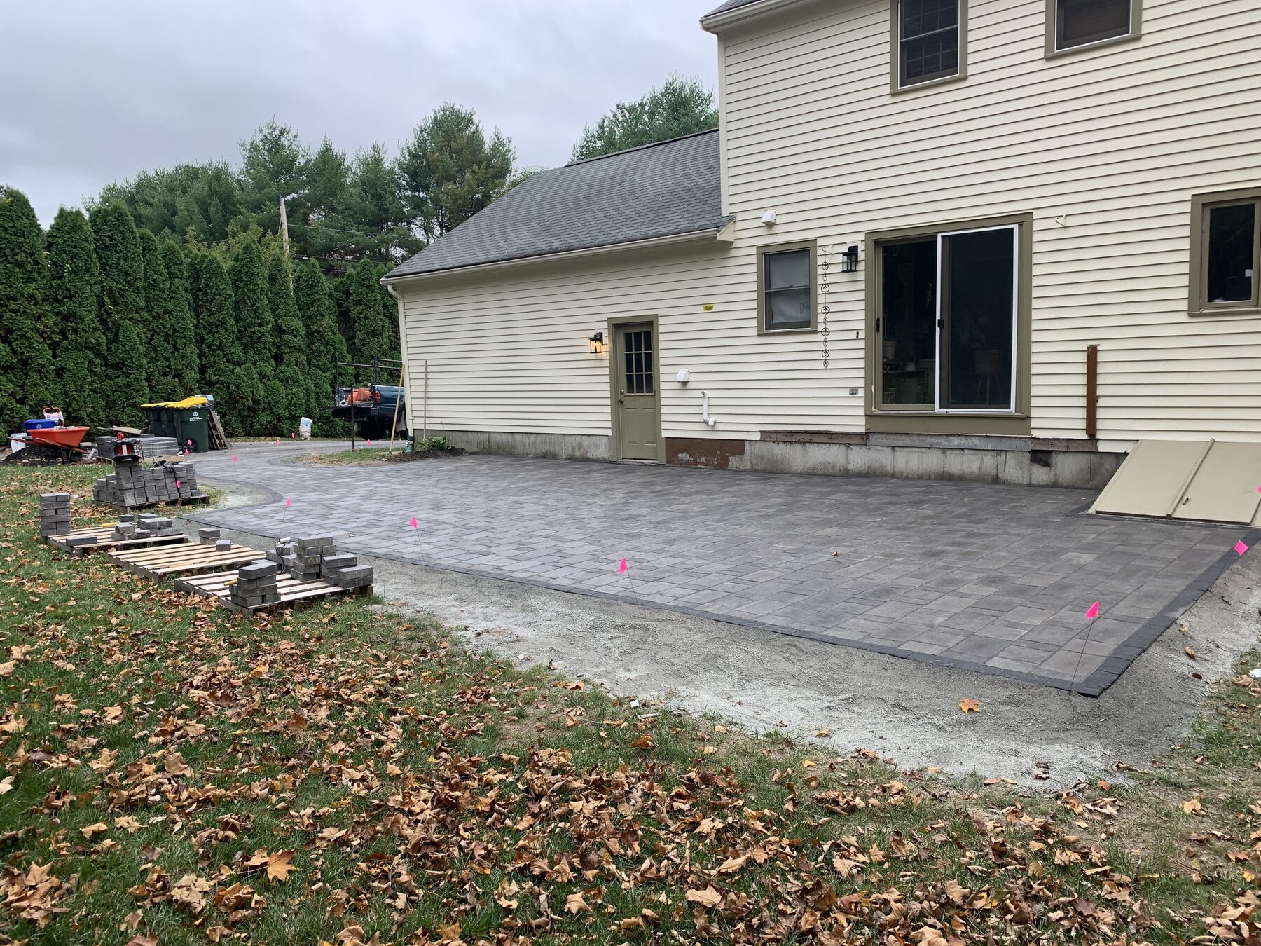 Wide finished view of concrete paver patio with charcoal border in Franklin Massachusetts