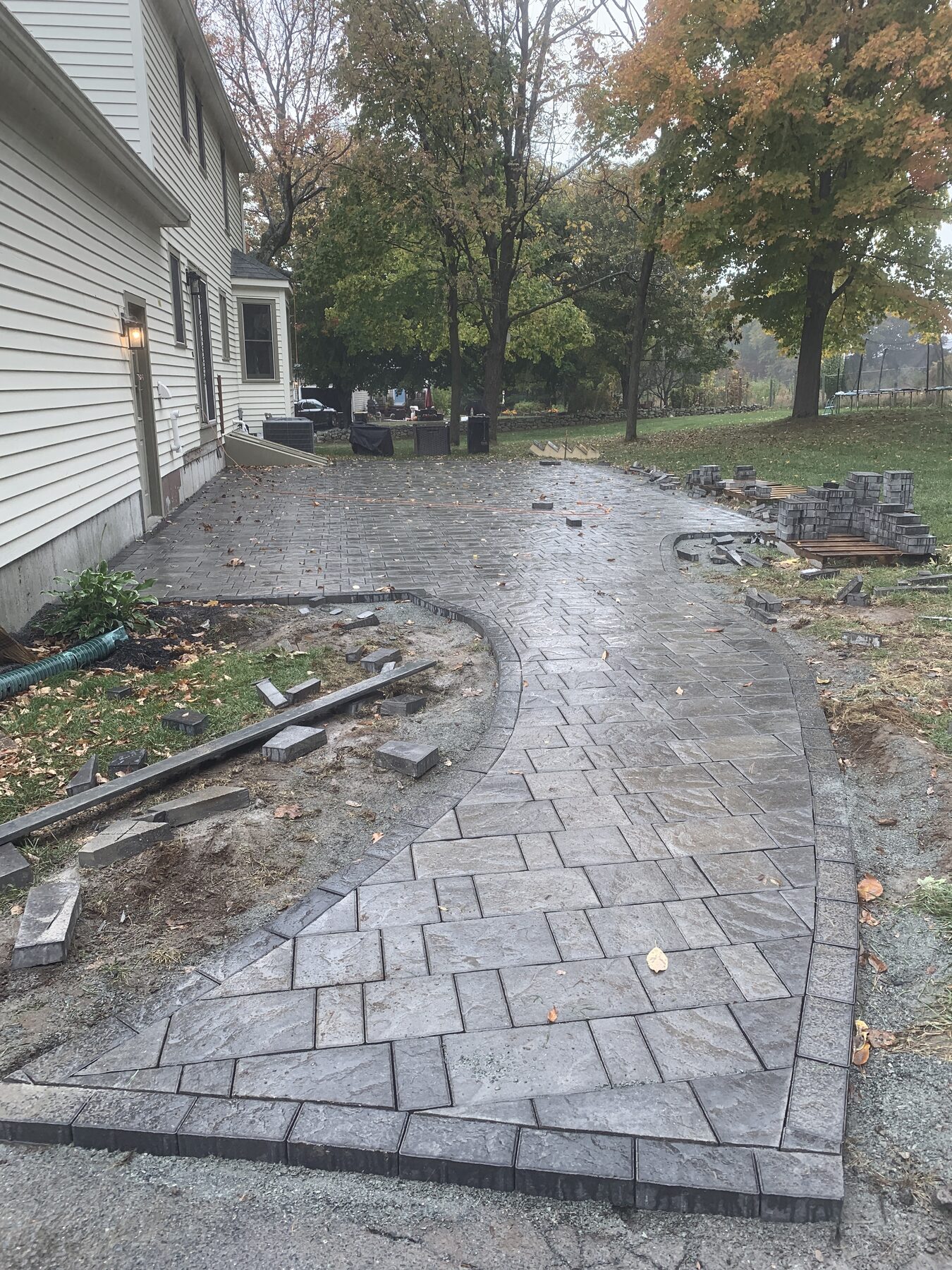 Concrete paver patio with curved charcoal border in Franklin Massachusetts